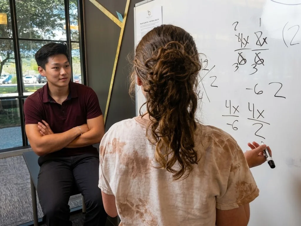 A Foley Prep tutor coaching a student at the whiteboard